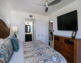 Primary Bedroom with En Suite Bath and Mounted TV
